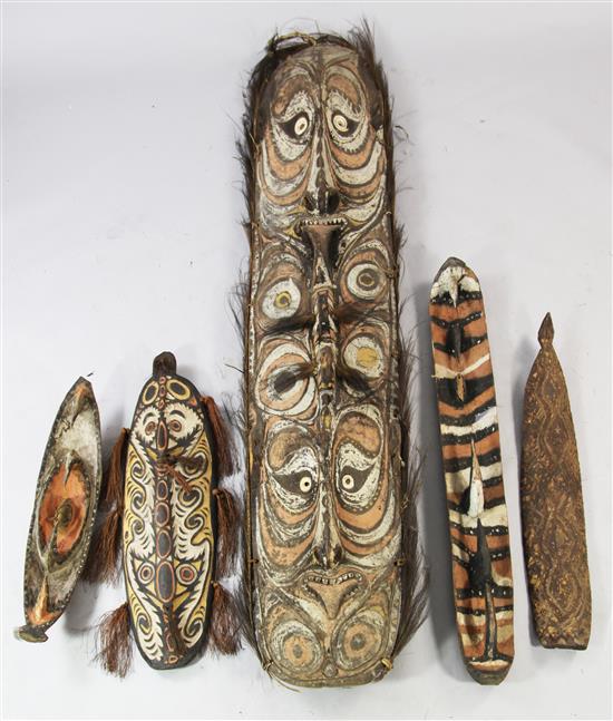 A Sepik River double mask shield, two garra masks, bullroarer etc (5)